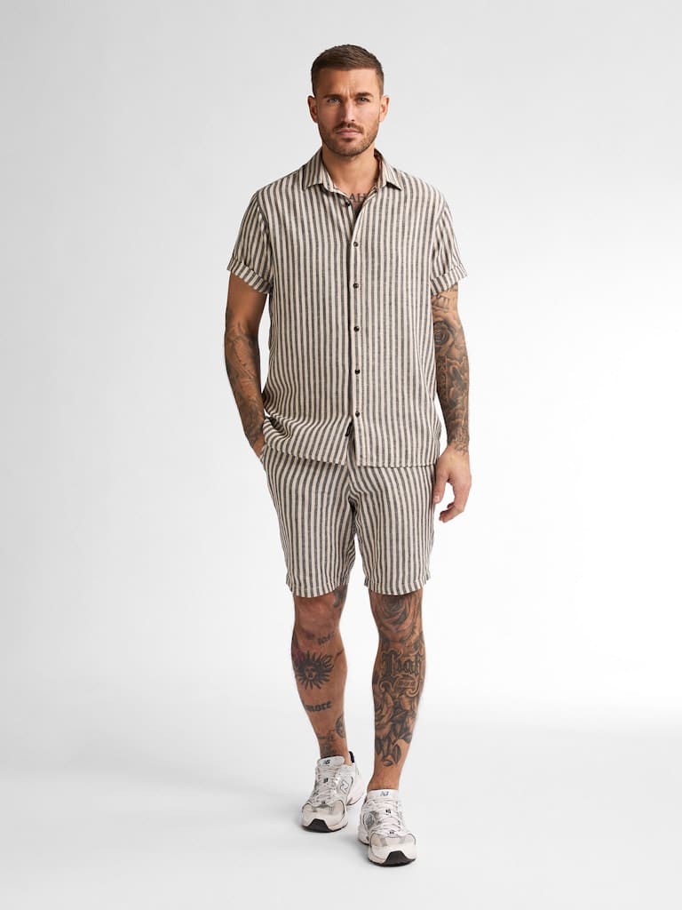 Chemise homme en lin rayée beige et bleue manches courtes Petrol Industries homme, coupe régulière, nouvelle collection printemps été 2025, du S au XXL, disponible chez Casual Senas avec livraison rapide partout en France, grandes villes comme Paris, Lyon, Marseille, Toulouse, Nantes, Bordeaux et dans tous les villages, Click & Collect à Sénas près de Salon-de-Provence, Avignon, Aix-en-Provence, Cavaillon et Saint-Rémy-de-Provence.